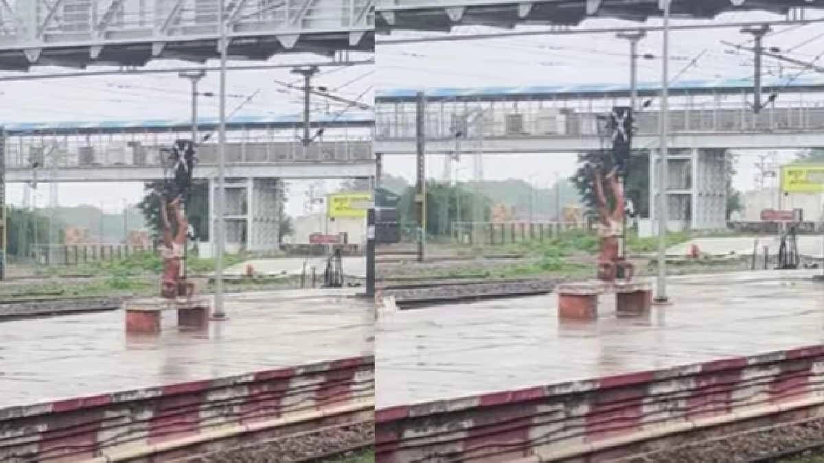 Elderly man does Yoga in rain on Railway Platform