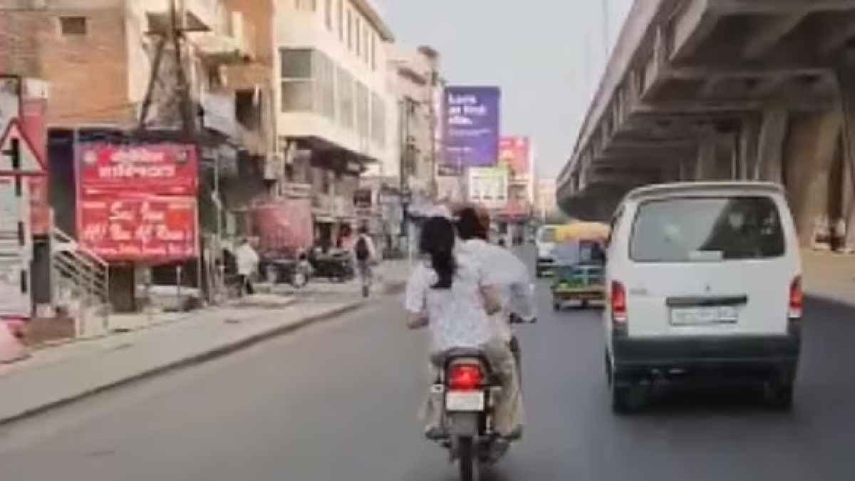 Woman beats Husband with slipper on moving Bike in Lucknow goes Viral